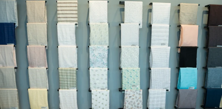 Linen fabrics folded on display rails